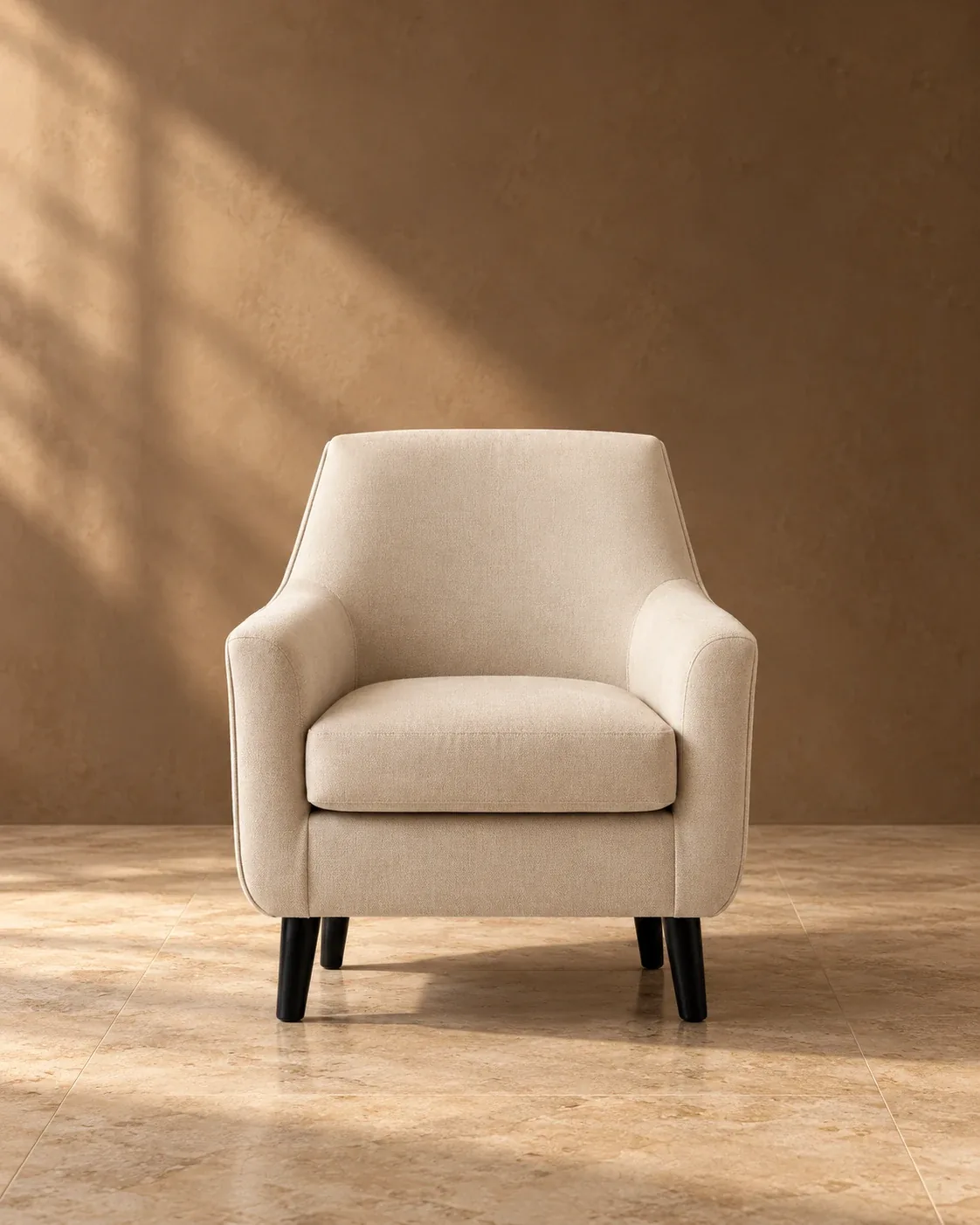 Beige upholstered armchair with black tapered legs